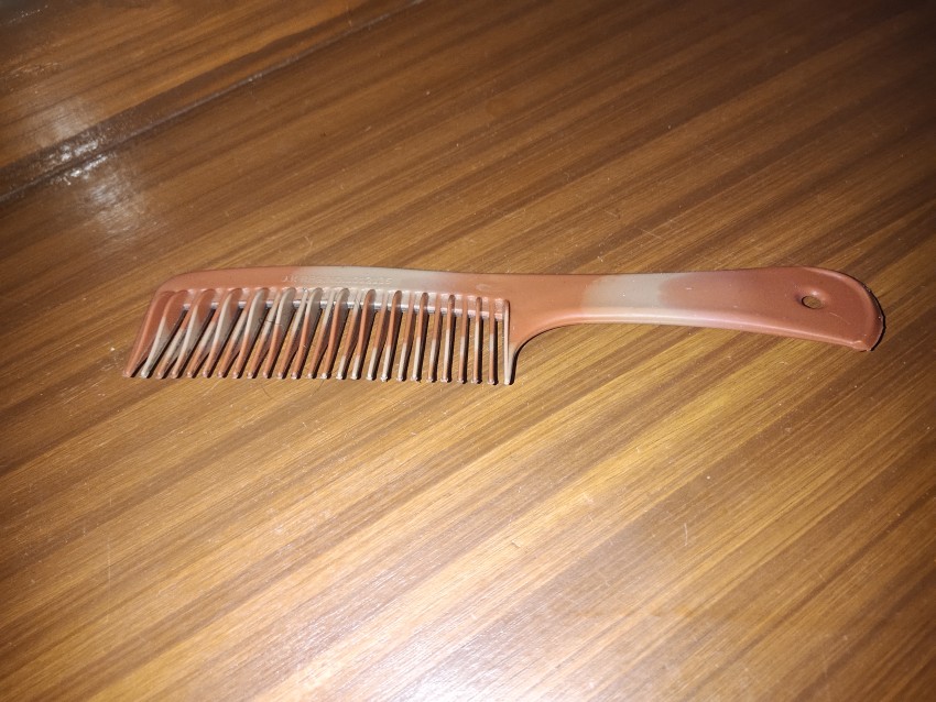 A brown color comb placed on the dressing table