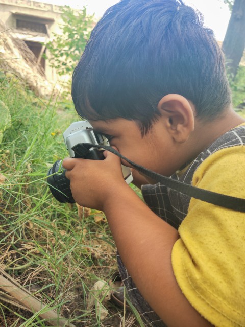 A child holding a camera looks like a professional photographer