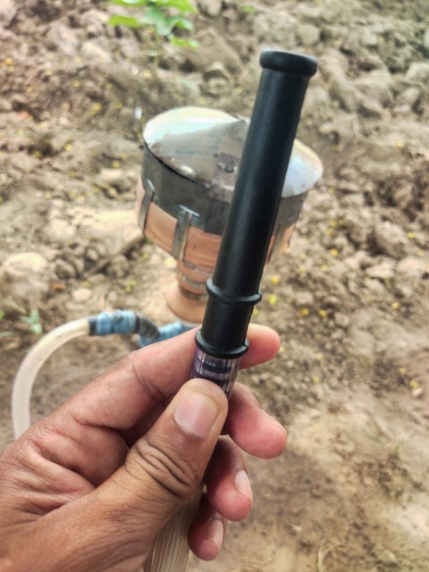 A native hookah pipe in hand finger from which the hookah smoke is drawn