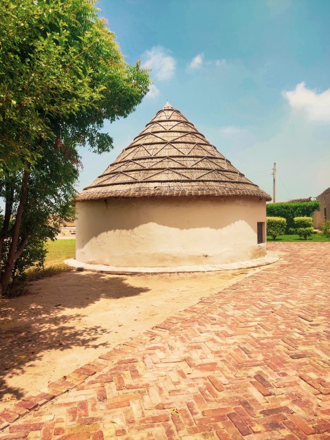 A round hut with beautiful sky portrait picture in a Pakistani village