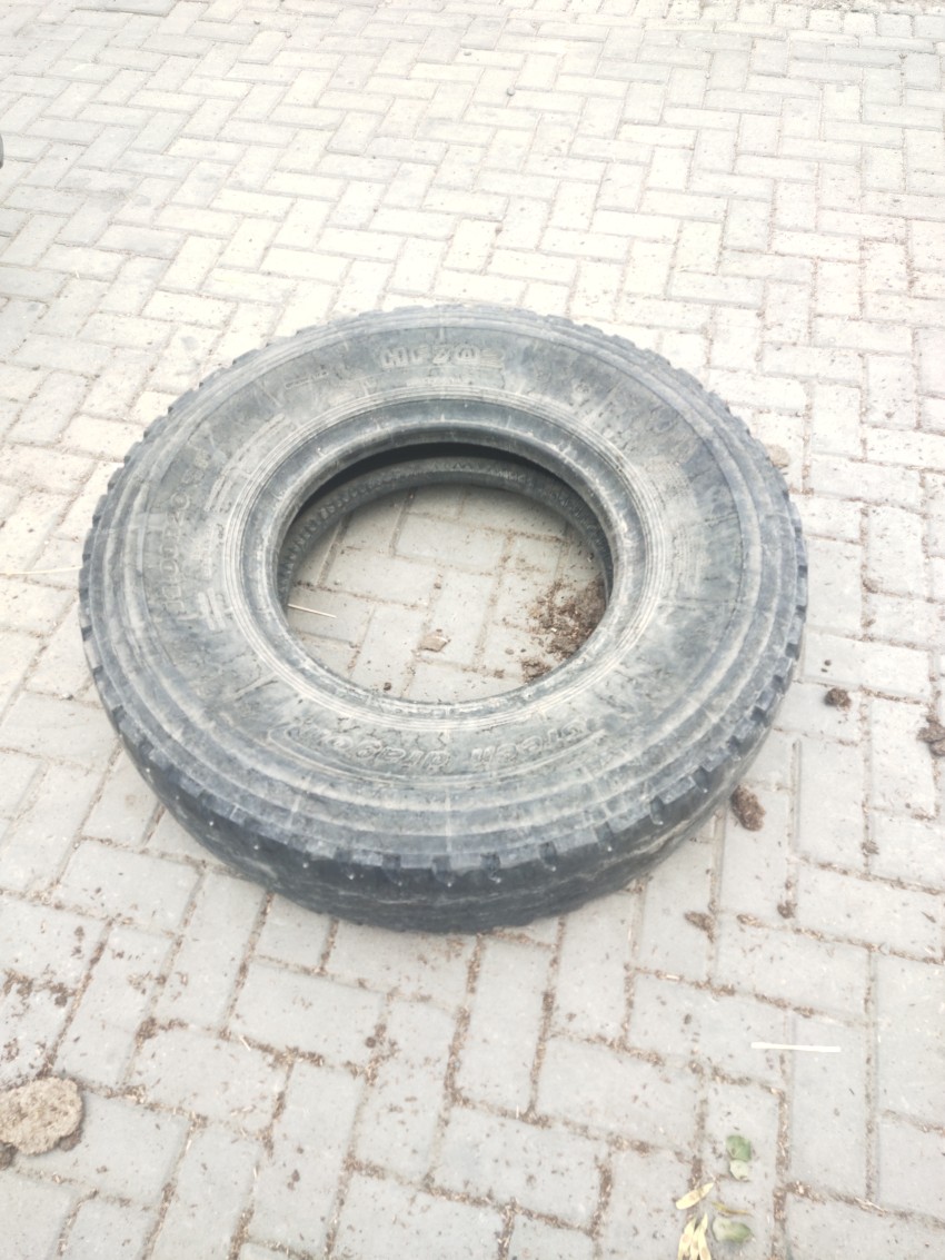 A truck tire is placed on the side of the road