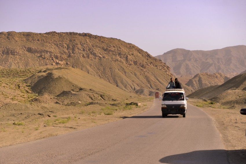 A van on the road with mountains view