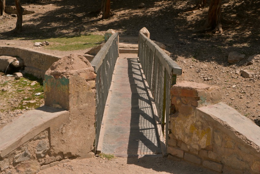An iron  foot bridge over the dried lake