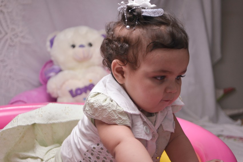 Baby photography   leaning forward while both hands on swimming pool without water