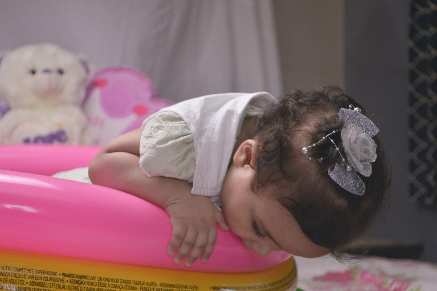 Baby photography   looking downward as trying inspect something