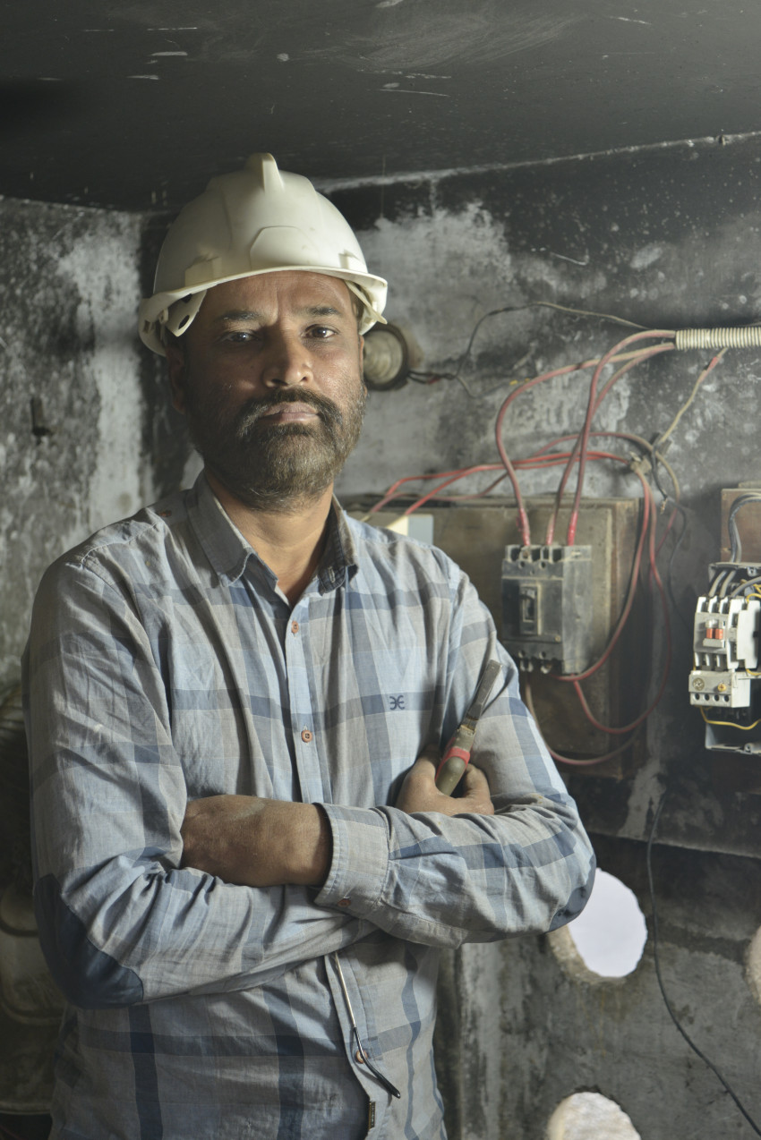 Electrician working in the electrical room.