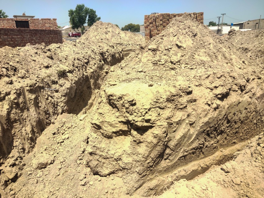 Excavation and brick scene for shop construction.