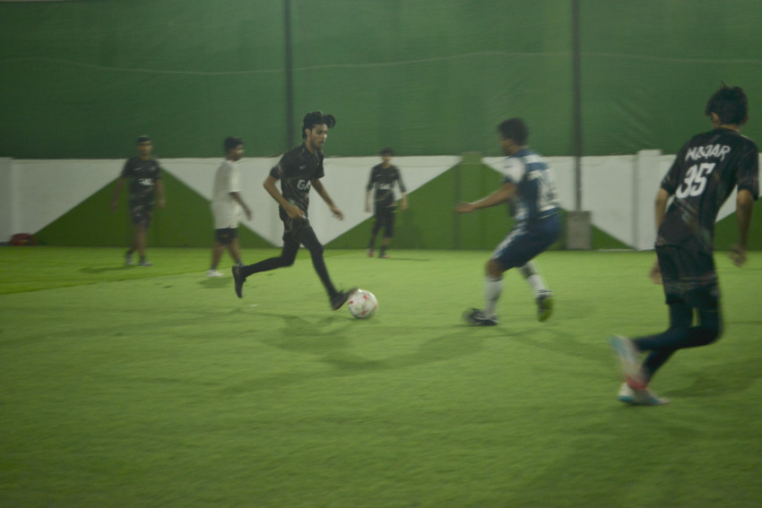 Futsal court team playing in a green floor ground