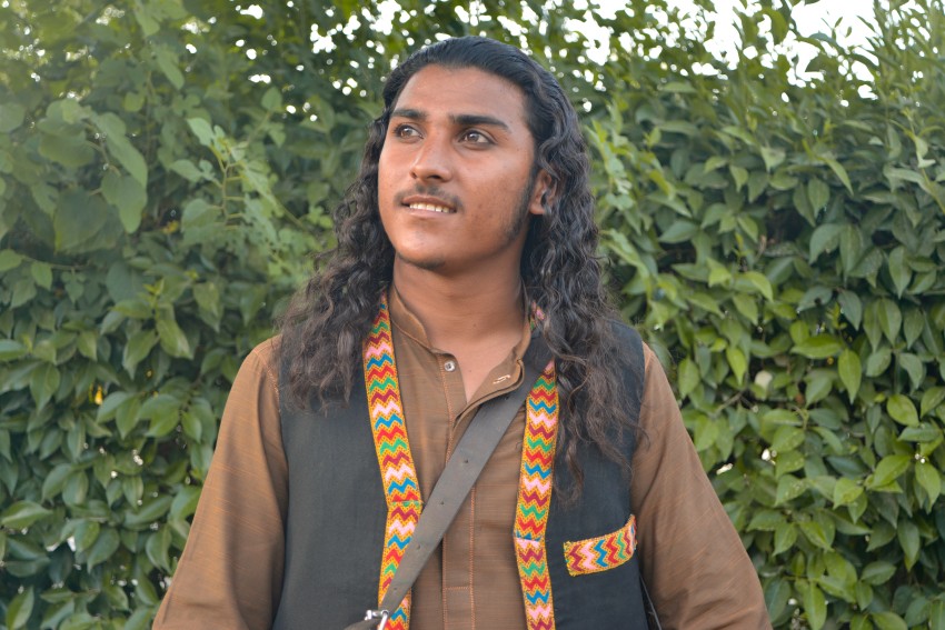 Long hair performer dark skin person with dark eyes