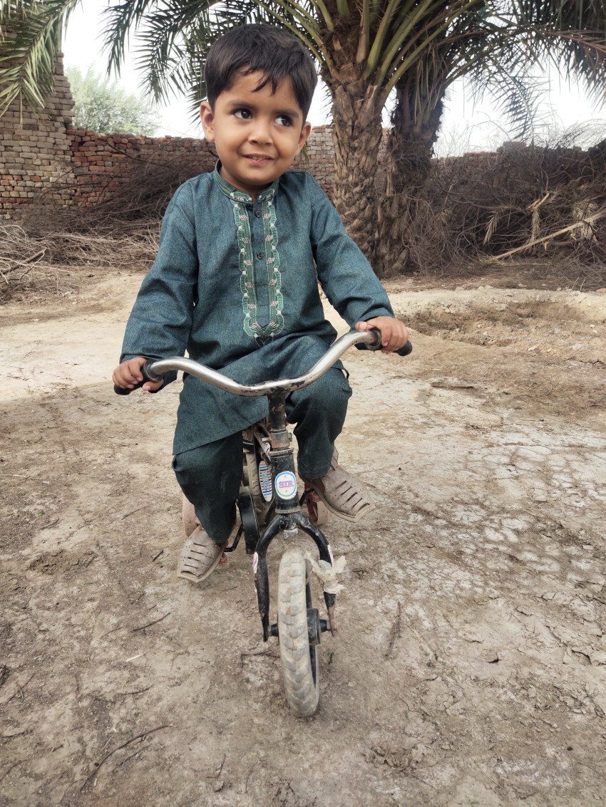 Muslim children riding bicycle