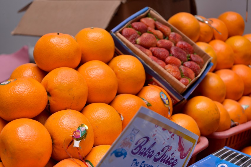 Orange with strawberries bunch in a box with a company titled Baba Juice