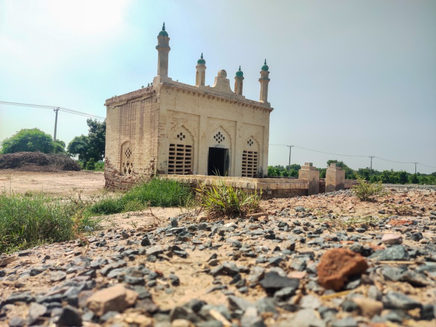 Side view of a very old mosque attached to the road