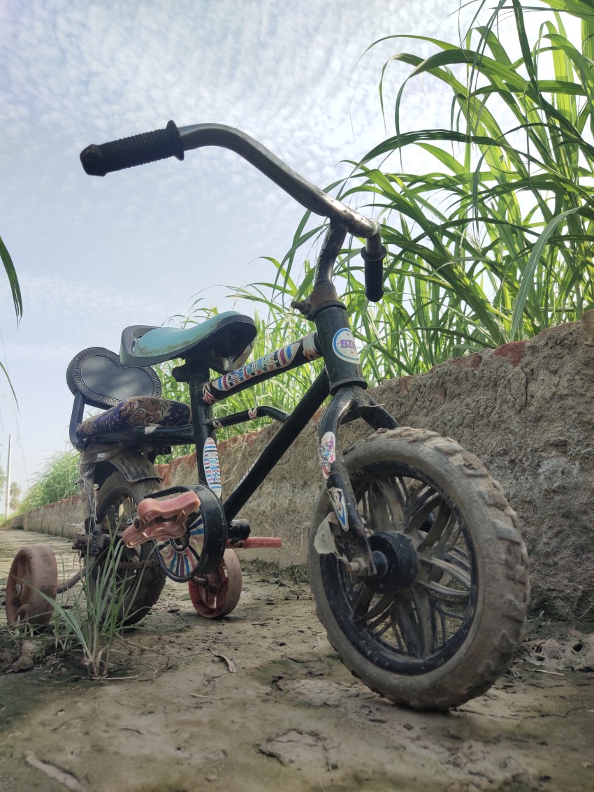 Small children's cycle which is currently standing outside in a dry canal