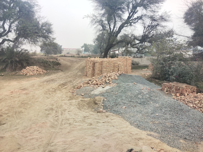 Small stones used in construction and lots of red bricks