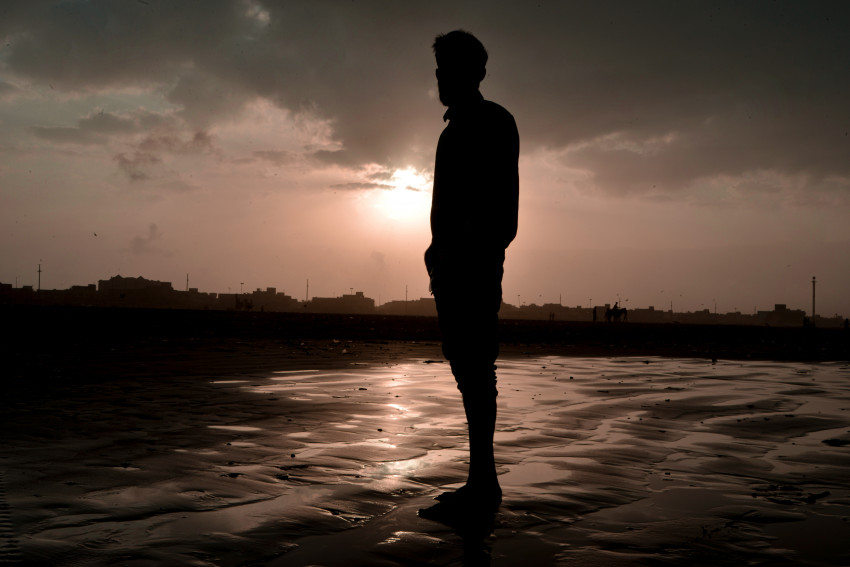 Sun Rise and Person Silhouette at Sea View, Karachi