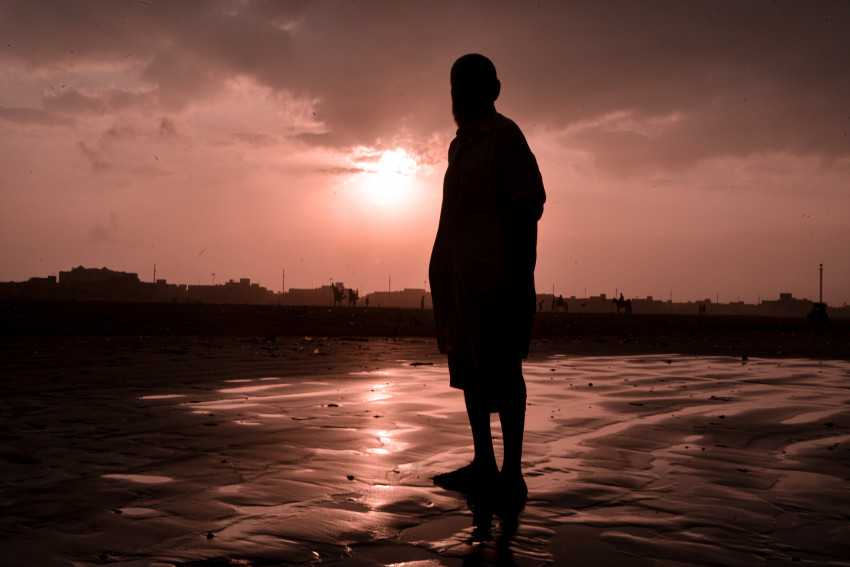 Sun Rise and Person Silhouette at Sea View, Karachi