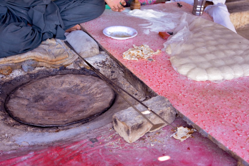 Tandoor with balls of dough covered with plastic for protection