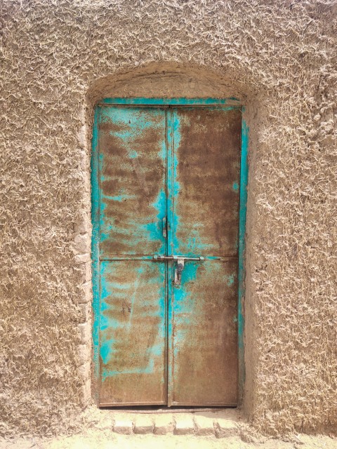 The door of the mud house is closed.