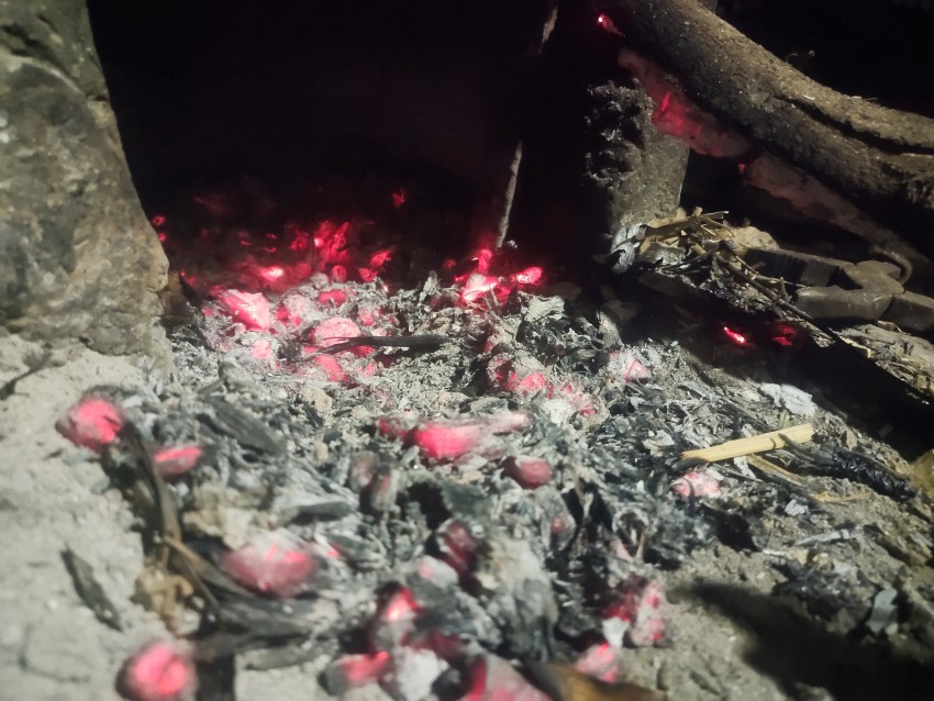 The fire of the home stove whose red coals are showing how hot they are