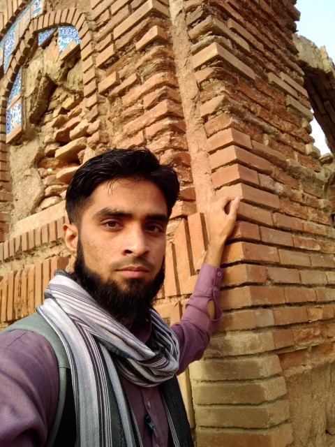 This is the scene of a boy posing in Thatta Badin, Asia's oldest and largest cemetery