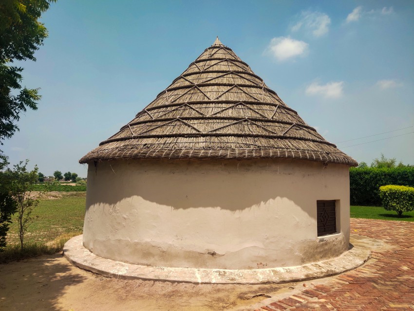 wide angle view a round hut with beautiful sky  in a Pakistani village